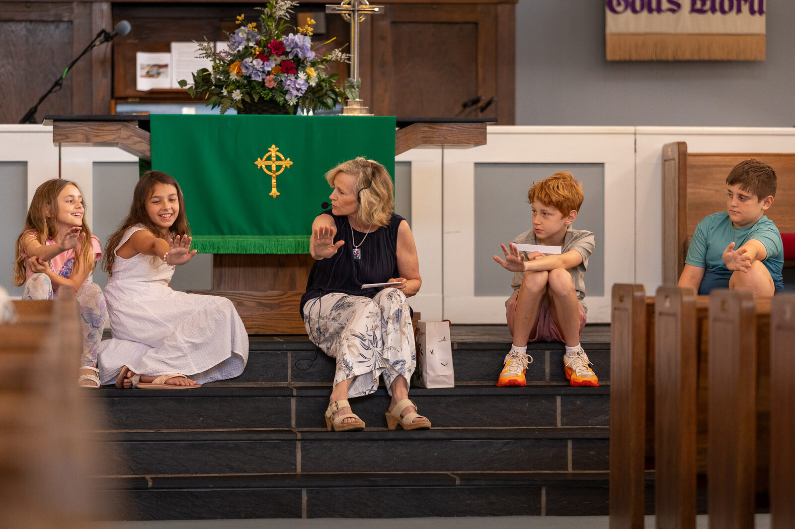 Children praying together at the children's message