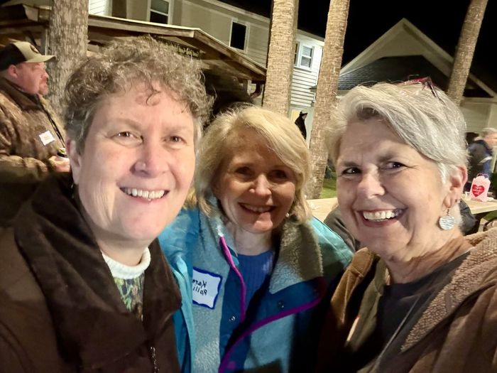 Friends laughing together at the oyster roast