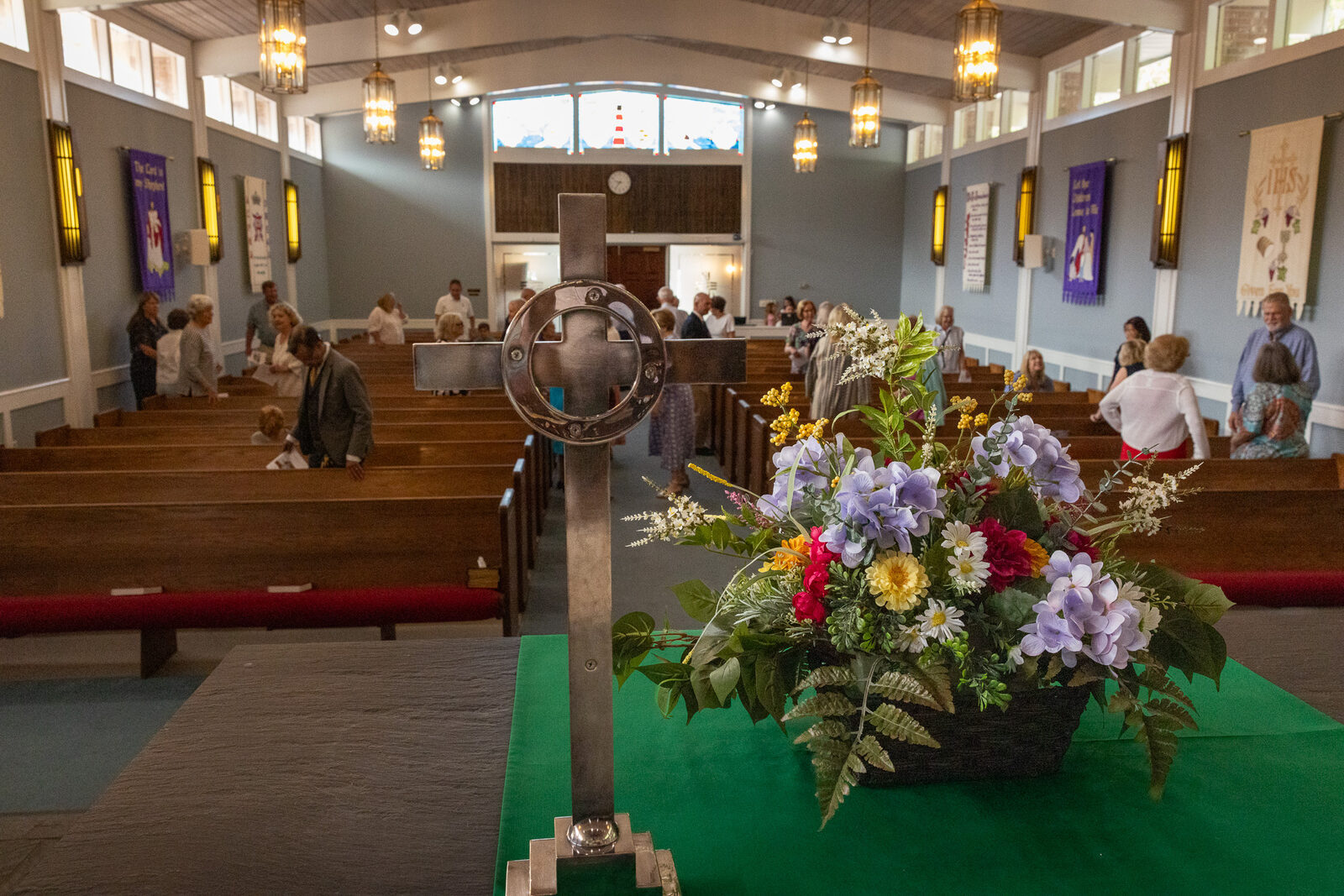 Flowers and the cross on the communion table